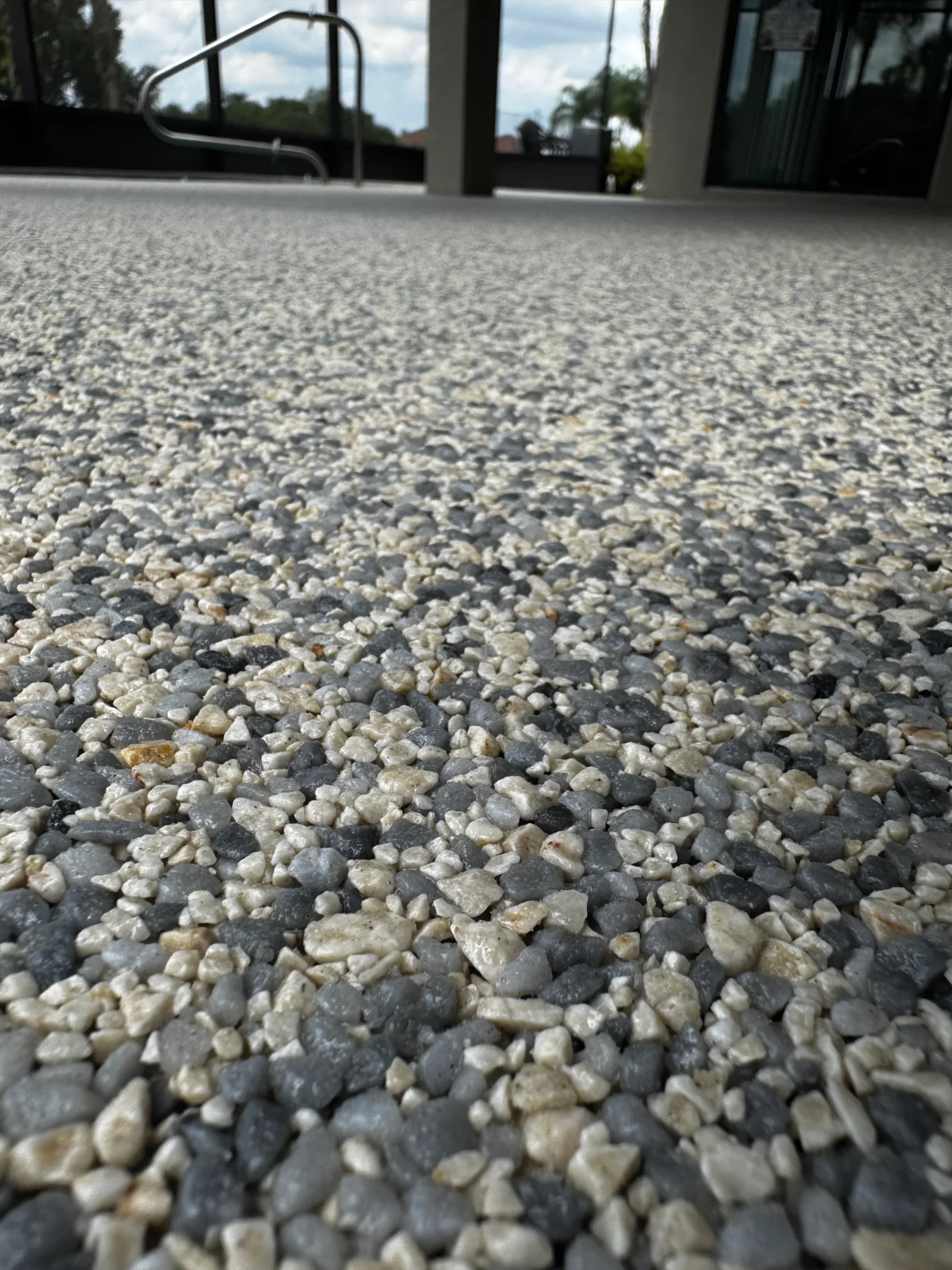 Polished concrete floor with gray and cream decorative aggregate finish