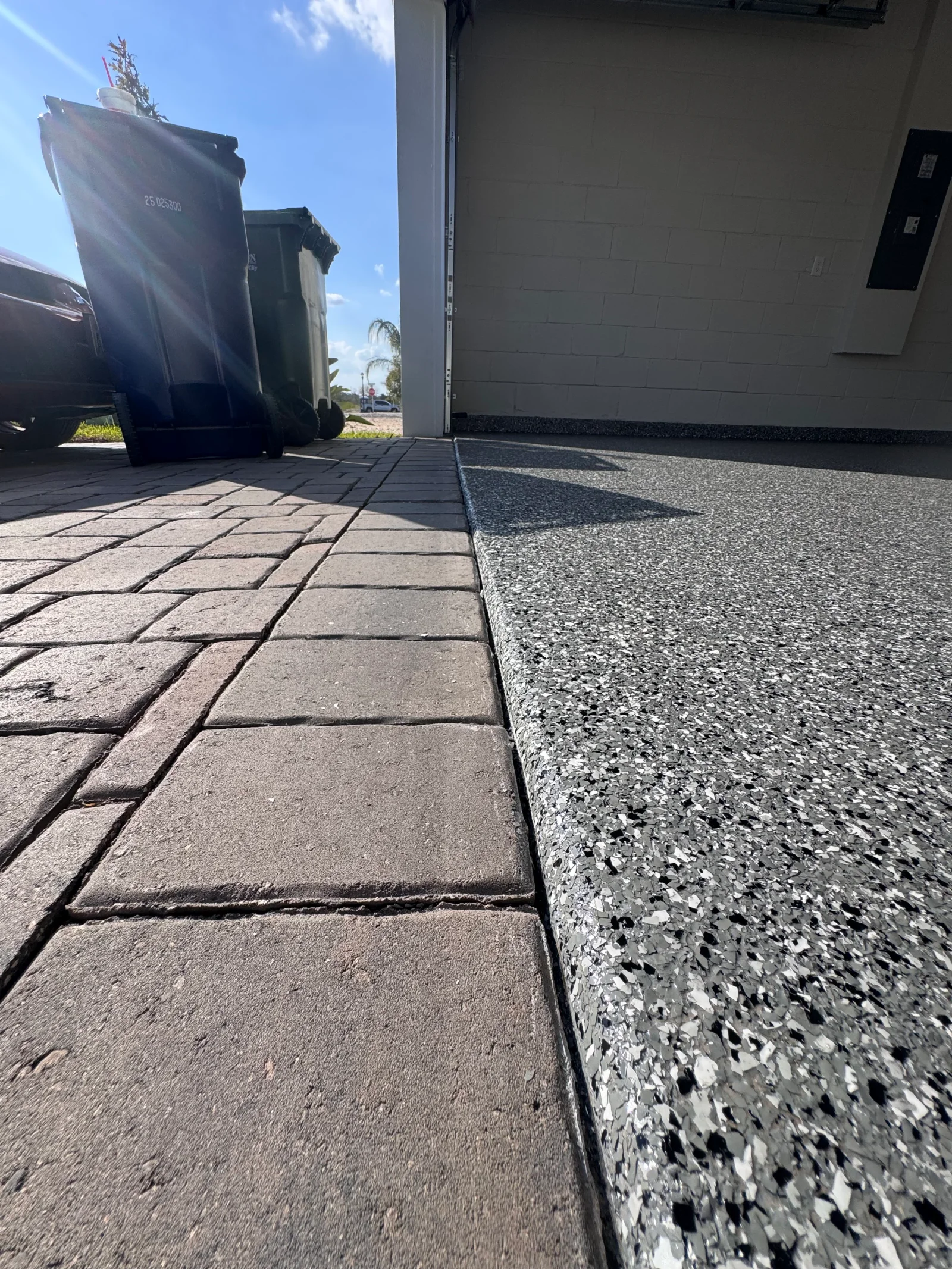 Driveway with paver and decorative aggregate concrete coating transition